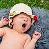 baby, yawn, crocheted_hat, blanket, outdoor, grass, greenery, infant, cute, sleepy, nature, soft_texture, relaxation, child, newborn, skin, portrait, headwear, lying_down, peaceful
