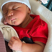 Kaÿden participe au concours pour gagner de l'argent avec cette photo : newborn, baby, sleeping, hat, blanket, red_clothing, infant, cozy, peaceful, closed_eyes, soft, cute, wrapped, resting, hand, portrait, indoors, child, new_born_tag, sleep
