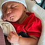 newborn, baby, sleeping, hat, blanket, red_clothing, infant, cozy, peaceful, closed_eyes, soft, cute, wrapped, resting, hand, portrait, indoors, child, new_born_tag, sleep