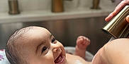 Gianna is registered to the contest to win money with this photo: baby, bath, smiling, water, bubbles, towel, sink, hand, faucet, skin, face, infant, happy, cute, child, cleaning, home, person, bathroom, playful