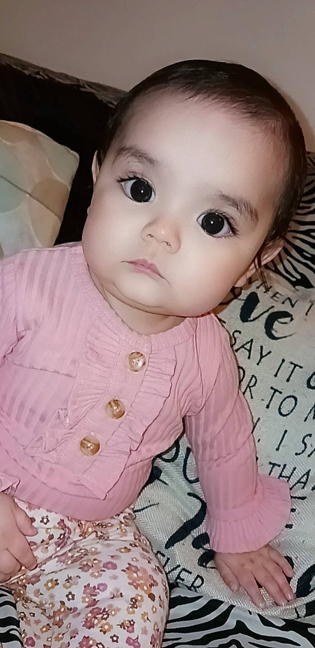 Azariah is registered to the contest to win money with this photo: baby, baby_toddler_clothing, cheek, chin, dress, eyelash, facial_expression, finger, forehead, human, human_body, iris, lip, mouth, nose, person, pink, product, skin, sleeve