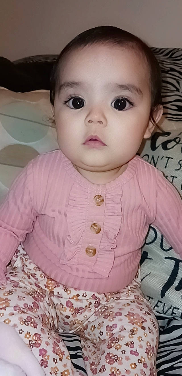 Azariah is registered to the contest to win money with this photo: baby, baby_toddler_clothing, cheek, chin, dress, eye, eyebrow, eyelash, forehead, head, iris, lip, mouth, neck, nose, organ, person, pink, skin, sleeve