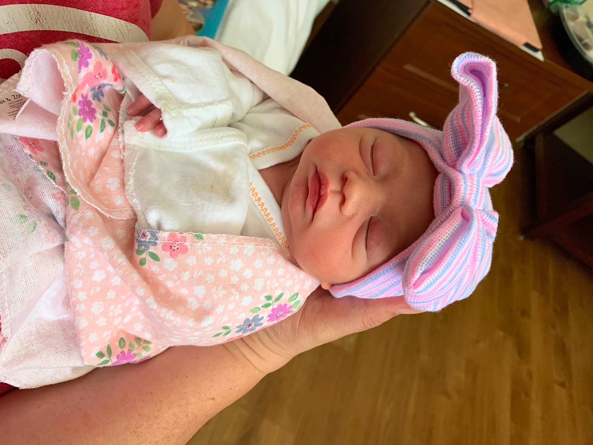 Tinsley is registered to the contest to win money with this photo: baby, baby_products, baby_toddler_clothing, cheek, child, comfort, eyelash, finger, flooring, hardwood, headwear, linens, nail, pattern, person, pink, room, skin, thumb, toddler