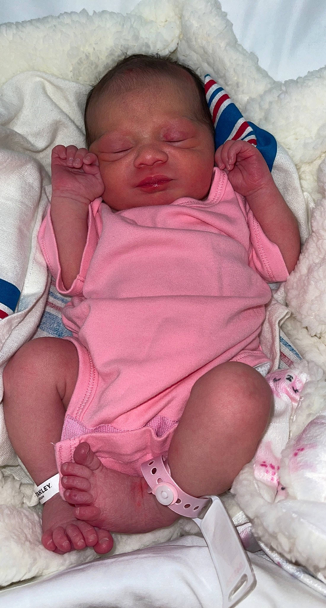 Tinsley is registered to the contest to win money with this photo: arm, baby, baby_toddler_clothing, cheek, comfort, eye, eyebrow, finger, hand, head, human_body, iris, leg, lip, mouth, nose, organ, person, pink, skin