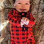 Emriella is registered to the contest to win money with this photo: baby, smiling, infant, red_clothing, plaid_pattern, blanket, soft_texture, lying_down, happy, cute, indoors, child, young, cheerful, hands, face, cozy, warm, comfortable, portrait