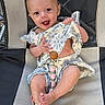 baby, infant, child, smiling, sitting, portrait, outdoor, mesh_chair, floral_clothing, dress, bare_feet, wooden_toy, happy, face, eyes, short_hair, playful, sunlight, photography, adorable
