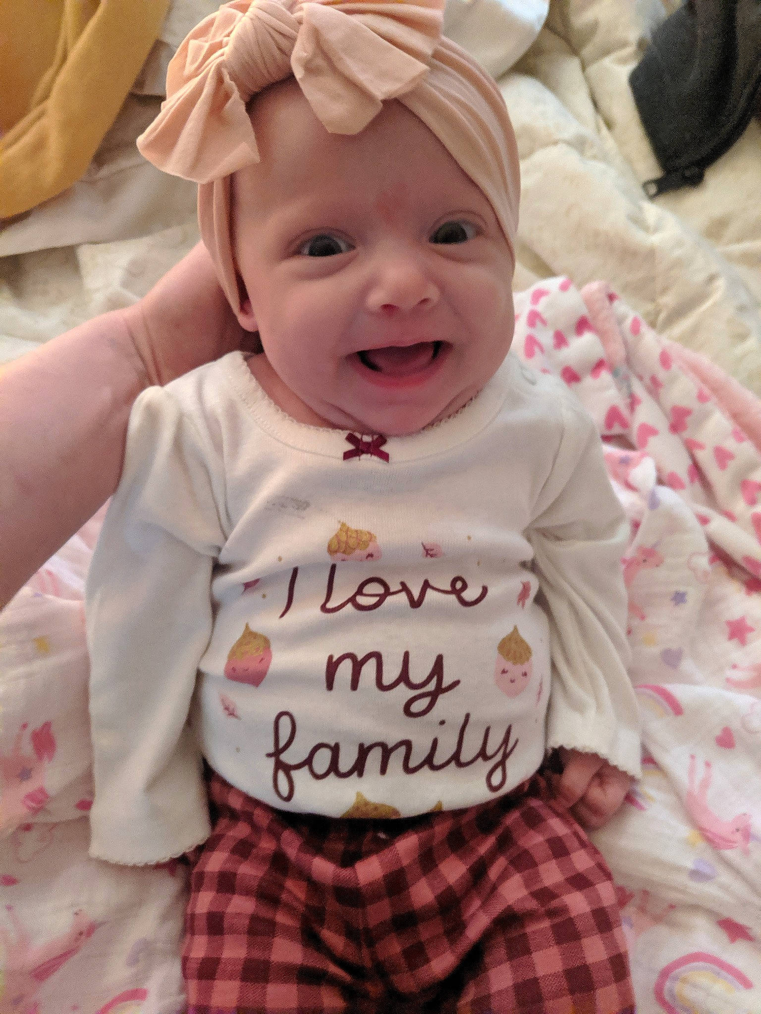 Abigail is registered to the contest to win money with this photo: baby, baby_laughing, baby_toddler_clothing, cheek, child, comfort, face, happy, headwear, linens, pattern, person, pink, plaid, skin, sleeve, smile, t_shirt, tartan, textile