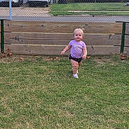 Willow joined the competition — help win amazing prizes! car, chain_link_fence, child, daylight, fence, grass, happy, outdoor, person, purple_shirt, residential, shorts, sidewalk, smiling, toddler, van, vehicles, walking, wooden_fence, yard
