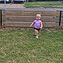 car, chain_link_fence, child, daylight, fence, grass, happy, outdoor, person, purple_shirt, residential, shorts, sidewalk, smiling, toddler, van, vehicles, walking, wooden_fence, yard