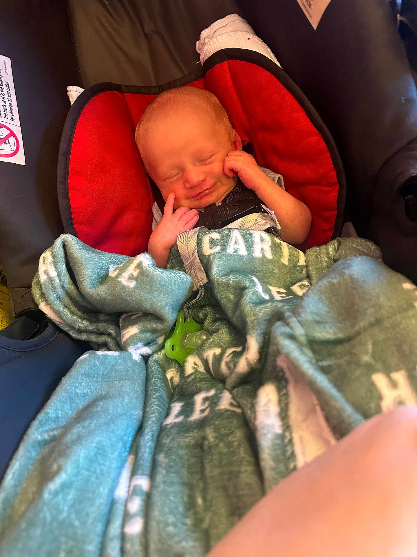 Carter joined the competition — help win amazing prizes! newborn, baby, car_seat, blanket, pacifier, red, green, sleeping, smiling, infant, child, cozy, cute, hands, wrapped, comfort, indoor, soft, peaceful, portrait