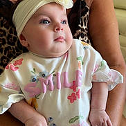 Tiara joined the competition — help win amazing prizes! adult_arm, baby, child, closeup, cute, expression, floral_clothing, flower, hands, headband, holding, indoor, infant, leopard_print, person, portrait, skin, smile_text, soft_lighting, toddler