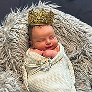 Trev is registered to the contest to win money with this photo: accessories, baby, blanket, crown, face, happy, head, jewelry, lady, newborn, person, photography, portrait, ring, sleeping, smile, yawning