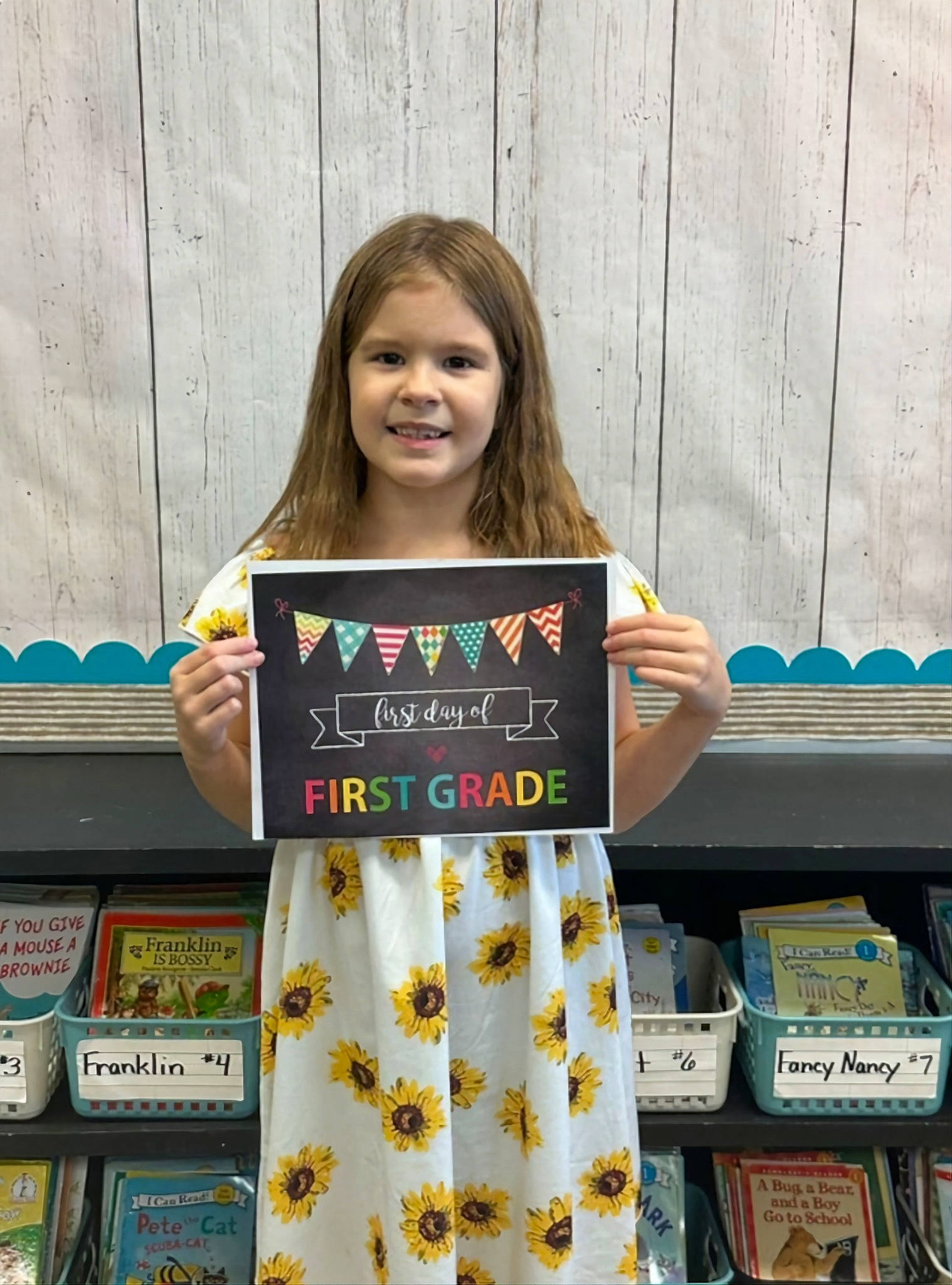 Sophie is registered to the contest to win money with this photo: bangs, child, happy, joy, pattern, person, play, publication, room, shelf, sleeve, smile, t_shirt, toddler