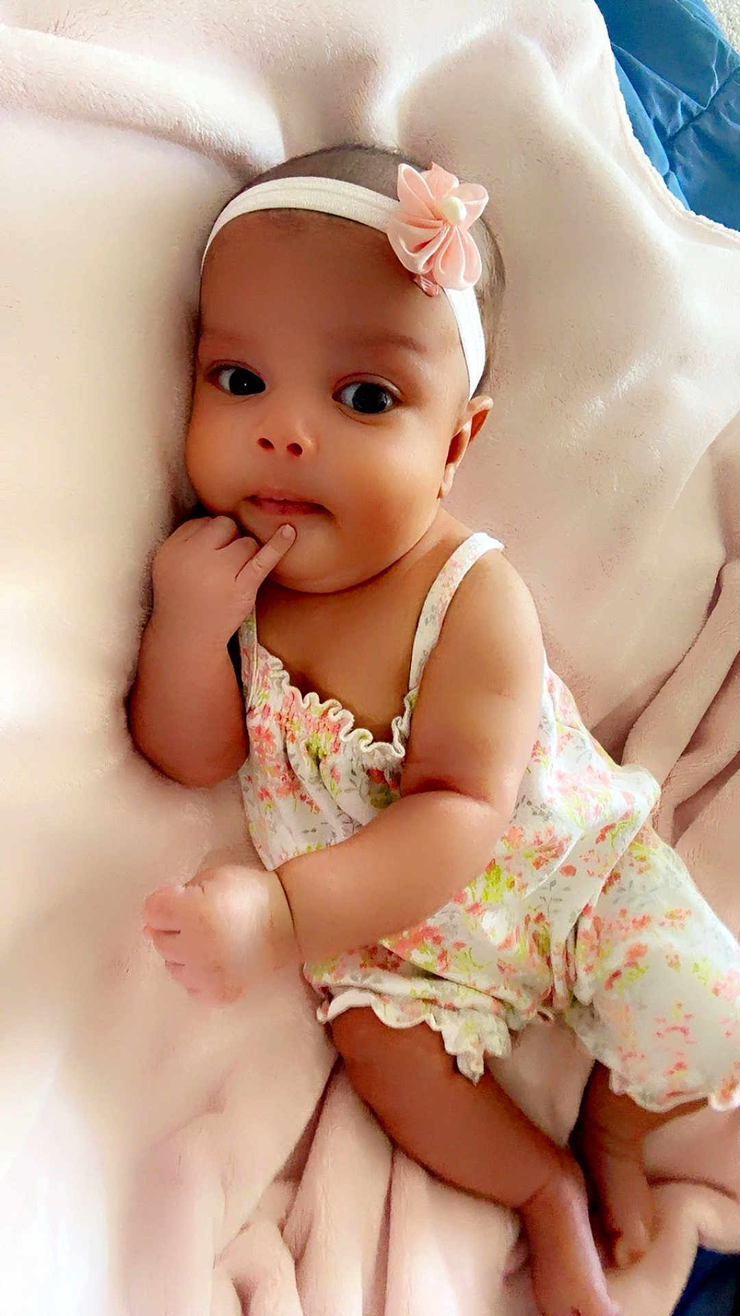 Jazariyah joined the competition — help win amazing prizes! baby, infant, child, blanket, headband, flower, hand, face, eyes, skin, clothing, cute, portrait, lying_down, soft, pink, floral_pattern, newborn, resting, indoor