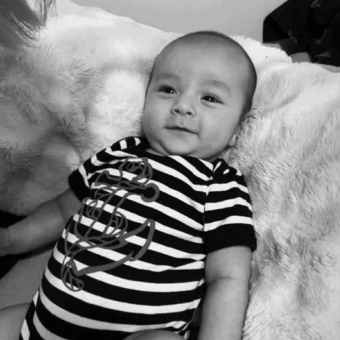 Seth joined the competition — help win amazing prizes! anchor_design, baby, baby_boy, blanket, child, comfort, cozy, cute, face, happy, human, indoor, infant, lying_down, onesie, portrait, smiling, soft_texture, striped_clothing, young