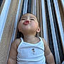 baby, child, infant, pouting, white_tank_top, striped_hammock, cute, expression, outdoor, summer, skin, face, arms, casual_clothing, relaxing, funny_face, portrait, one_person, childhood, leisure