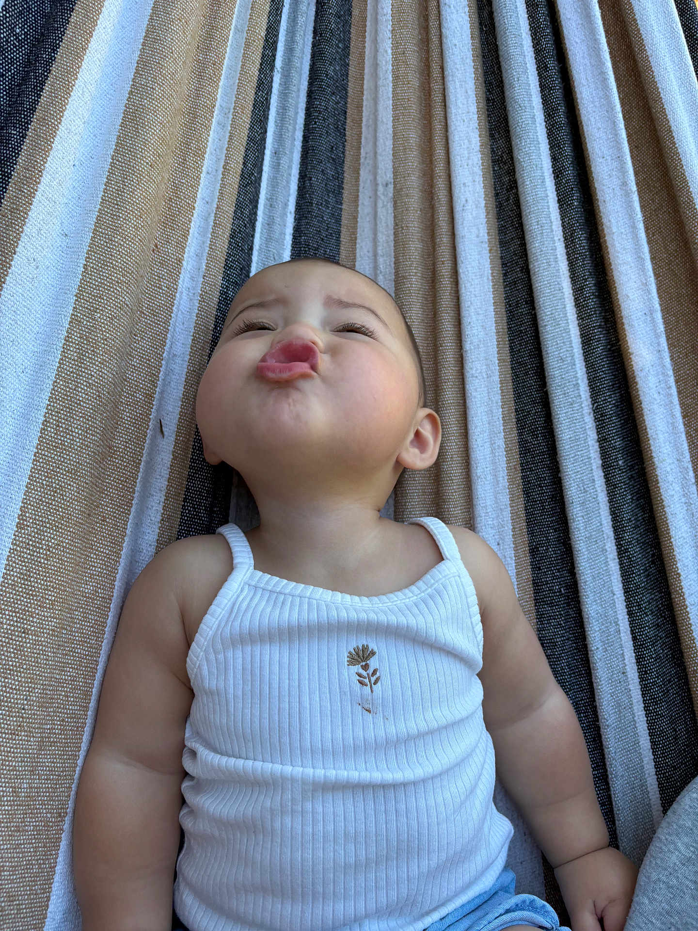 Cecilia joined the competition — help win amazing prizes! baby, child, infant, pouting, white_tank_top, striped_hammock, cute, expression, outdoor, summer, skin, face, arms, casual_clothing, relaxing, funny_face, portrait, one_person, childhood, leisure