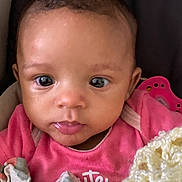 Davika is registered to the contest to win money with this photo: baby, infant, face, eyes, pink_clothing, blanket, pacifier, cute, close_up, portrait, child, young, indoors, cozy, skin, expression, head, apparel, warm, snuggled