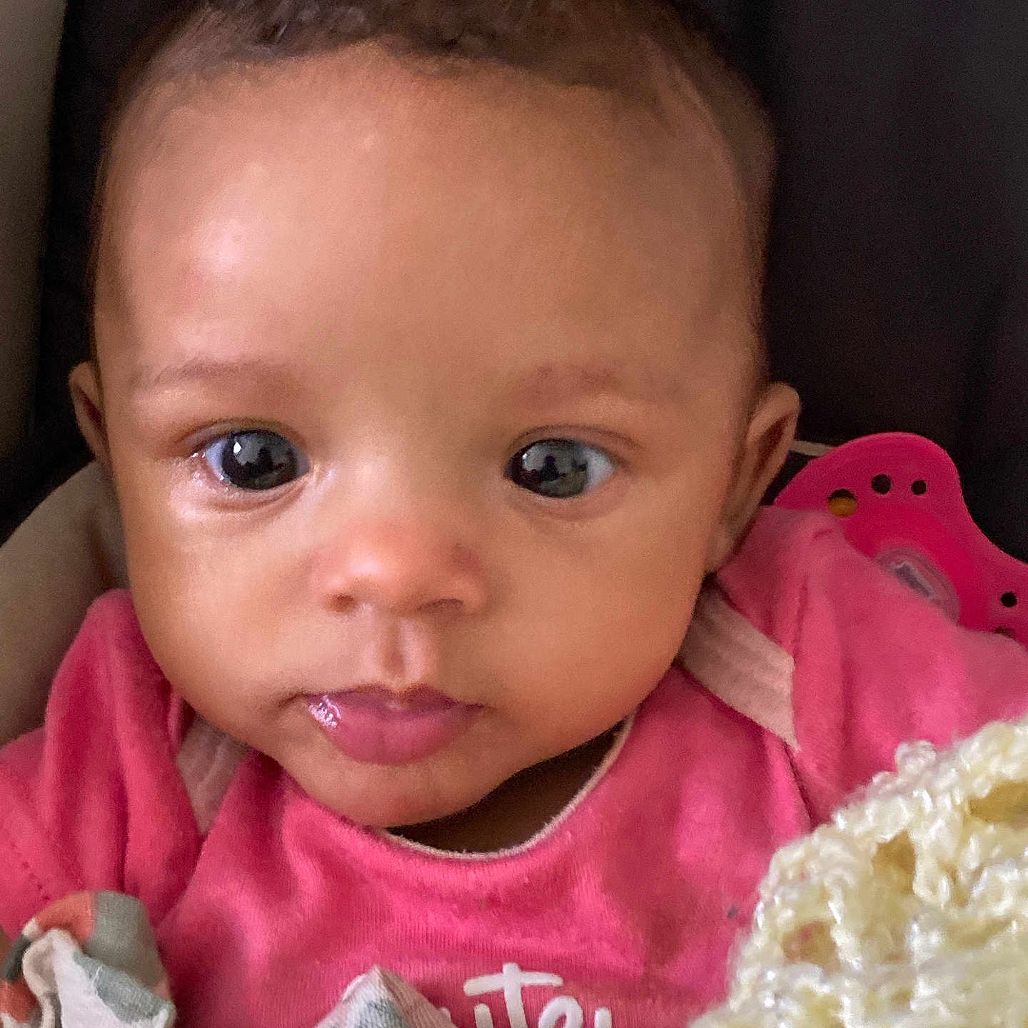 Davika is registered to the contest to win money with this photo: baby, infant, face, eyes, pink_clothing, blanket, pacifier, cute, close_up, portrait, child, young, indoors, cozy, skin, expression, head, apparel, warm, snuggled