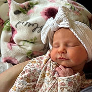 Lucy joined the competition — help win amazing prizes! baby, newborn, sleeping, headband, onesie, floral_pattern, blanket, soft, cute, peaceful, hand, infant, closeup, portrait, indoors, child, resting, skin, headwear, cozy