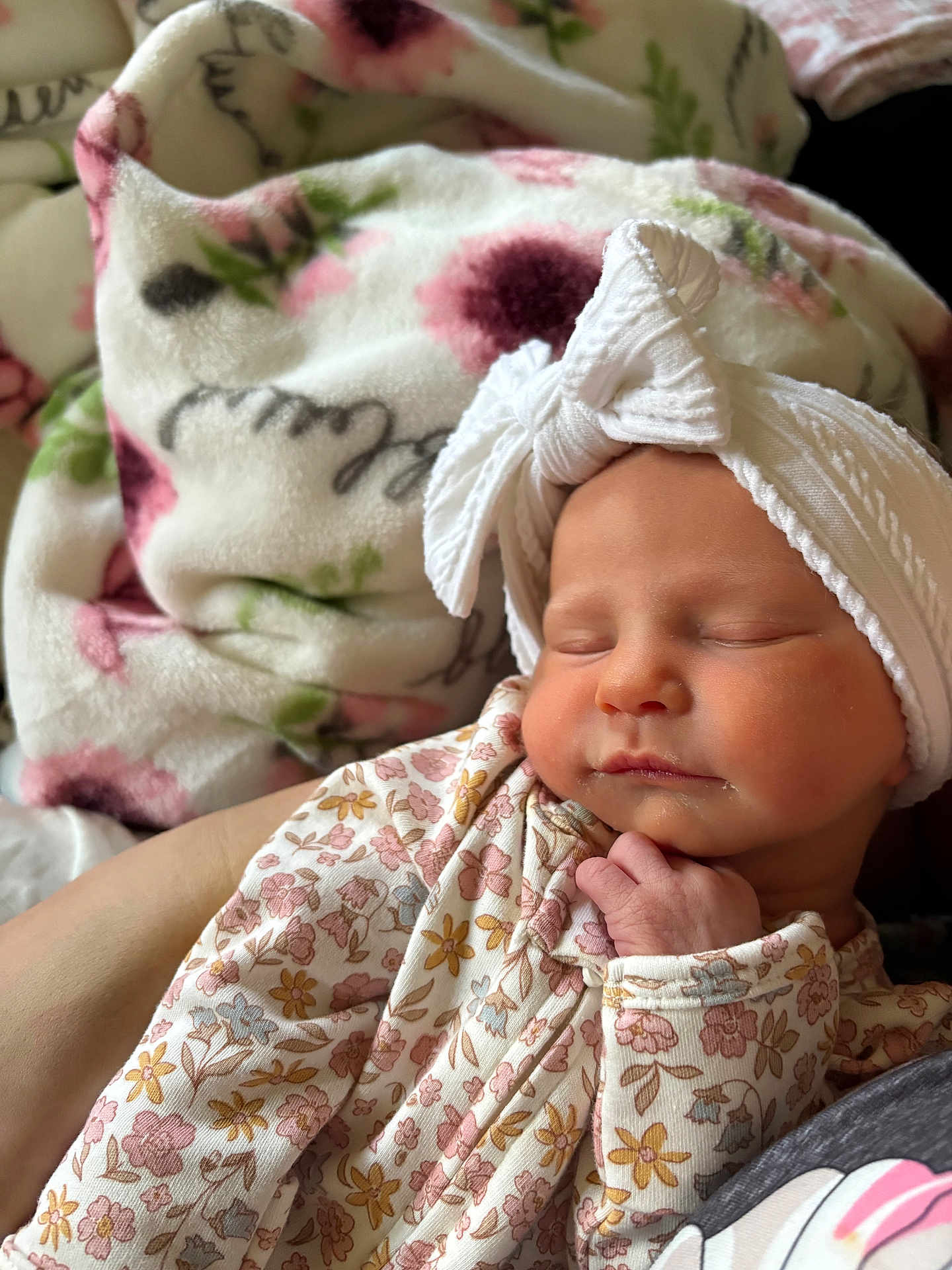 Lucy joined the competition — help win amazing prizes! baby, newborn, sleeping, headband, onesie, floral_pattern, blanket, soft, cute, peaceful, hand, infant, closeup, portrait, indoors, child, resting, skin, headwear, cozy