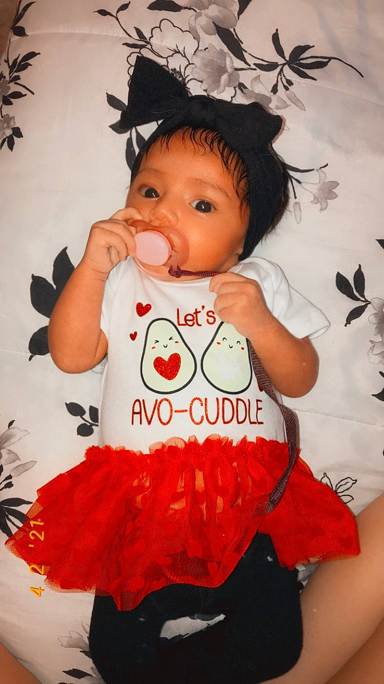 Marianna is registered to the contest to win money with this photo: baby, baby_toddler_clothing, beauty, cheek, child, facial_expression, finger, gesture, hairstyle, happy, organ, pattern, person, pink, product, skin, sleeve, t_shirt, textile, toddler