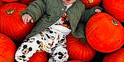 Louie joined the competition — help win amazing prizes! baby, child, pumpkins, orange, smiling, outdoor, fall, autumn, clothing, jacket, cute, playful, mickey_mouse, nature, seasonal, harvest, person, sitting, happy, festive