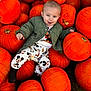 baby, child, pumpkins, orange, smiling, outdoor, fall, autumn, clothing, jacket, cute, playful, mickey_mouse, nature, seasonal, harvest, person, sitting, happy, festive