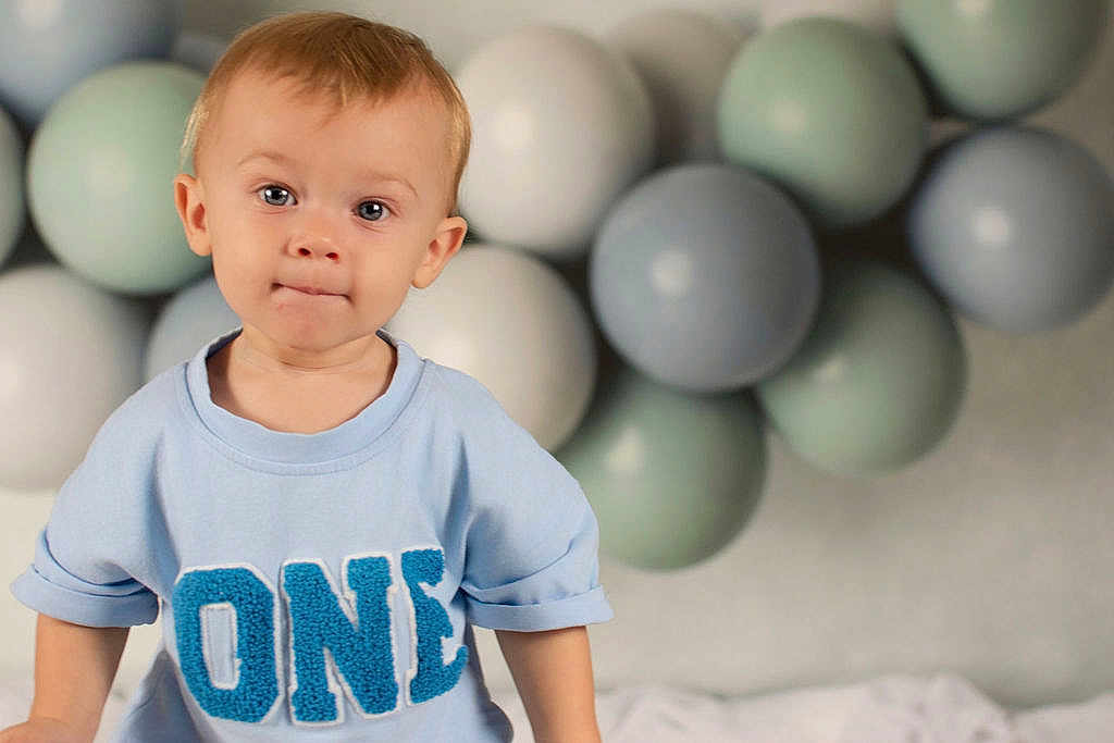 Ryder joined the competition — help win amazing prizes! toddler, child, boy, blue_shirt, one_text, balloons, pastel_colors, portrait, face, expression, indoor, celebration, party, cute, young_child, casual_clothing, short_hair, light_skin, happy, baby