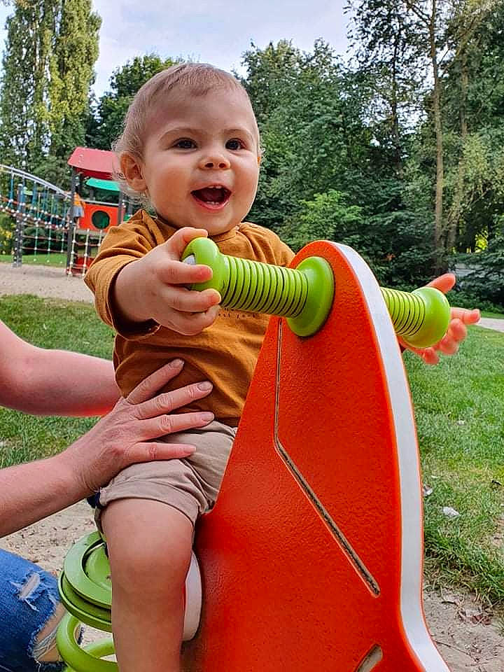 Thayron a rejoint le concours — aidez-le/la à gagner de superbes lots ! baby_playing_with_toys, child, chute, fun, grass, green, happy, leisure, outdoor_play_equipment, outdoor_recreation, people_in_nature, person, plant, playground, playground_slide, recreation, shorts, sky, smile, toddler