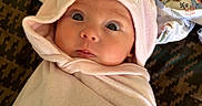 Amethyst joined the competition — help win amazing prizes! baby, infant, wrapped, blanket, hood, ears, cute, wide_eyes, curious, soft_fabric, patterned_background, pink, face, portrait, lying_down, clothing, child, toddler, indoor, closeup