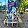 child, children, playground, slide, baby, park, outdoor, fun, play, friends, daylight, trees, grass, woodchips, smile, casual_clothing, happy, summer, recreation, metal_slide