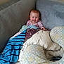 Stella is registered to the contest to win money with this photo: baby, smile, couch, blanket, pillow, cozy, indoor, child, happy, infant, clothing, fabric, comfort, home, cute, resting, warm, soft, person, seated