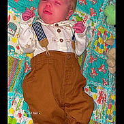 Jackson joined the competition — help win amazing prizes! baby, infant, quilt, colorful, fox_pattern, clothing, pants, suspenders, lying_down, cute, child, toddler, newborn, face, sleepy, patterned, soft, fabric, indoors, cozy