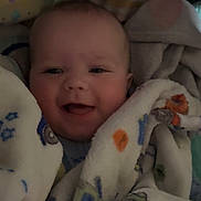 Jackson is registered to the contest to win money with this photo: baby, blanket, bottle, smile, infant, cozy, wrapped, happy, face, child, soft, cute, indoor, portrait, newborn, clothing, comfort, person, baby_bottle, warm