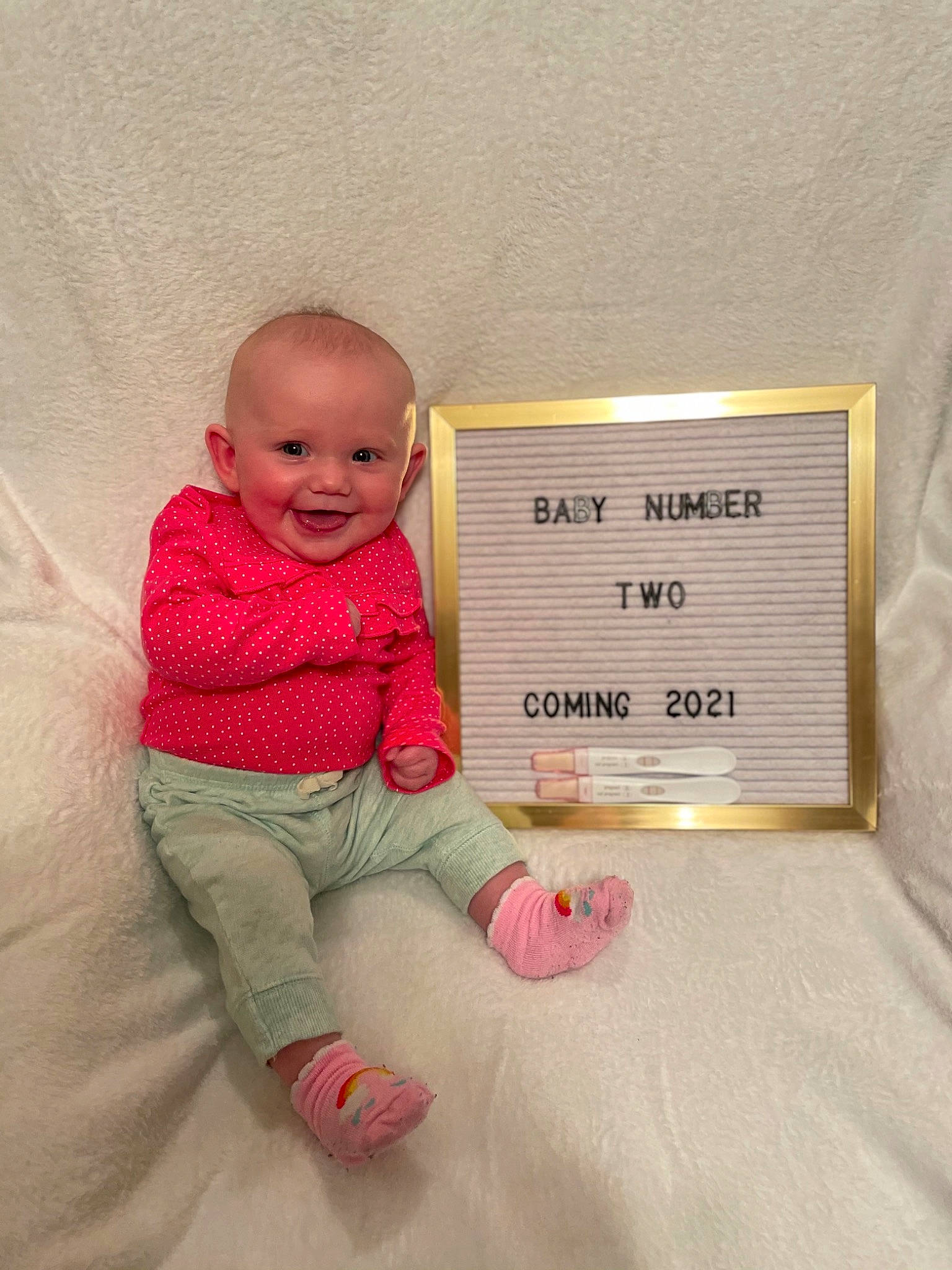 Rilynn is registered to the contest to win money with this photo: baby, baby_toddler_clothing, cheek, child, comfort, flooring, font, handwriting, happy, joy, linens, magenta, paper_product, pattern, person, rectangle, room, sitting, sleeve, smile