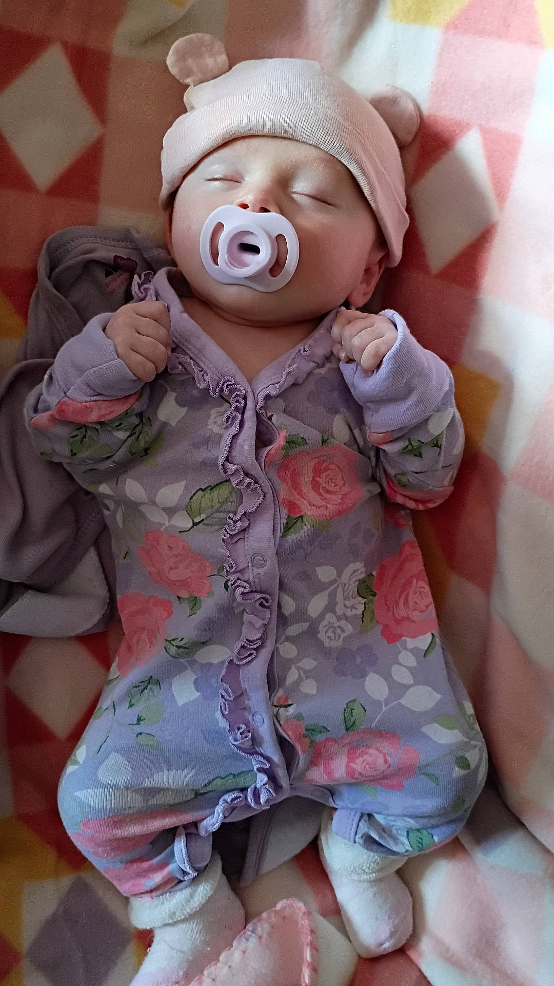 Nova joined the competition — help win amazing prizes! baby, bear_ears, bed, blanket, closed_eyes, cute, floral_clothing, hat, indoors, infant, lying_down, mittens, onesie, pacifier, peaceful, pink, portrait, purple, sleeping, socks