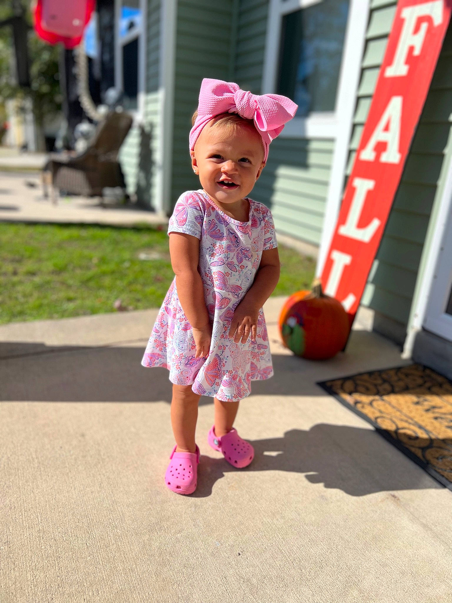 Ariah joined the competition — help win amazing prizes! baby, baby_toddler_clothing, child, dress, flooring, fun, grass, happy, hat, leisure, magenta, pattern, person, pink, plant, play, recreation, sun_hat, toddler, vacation