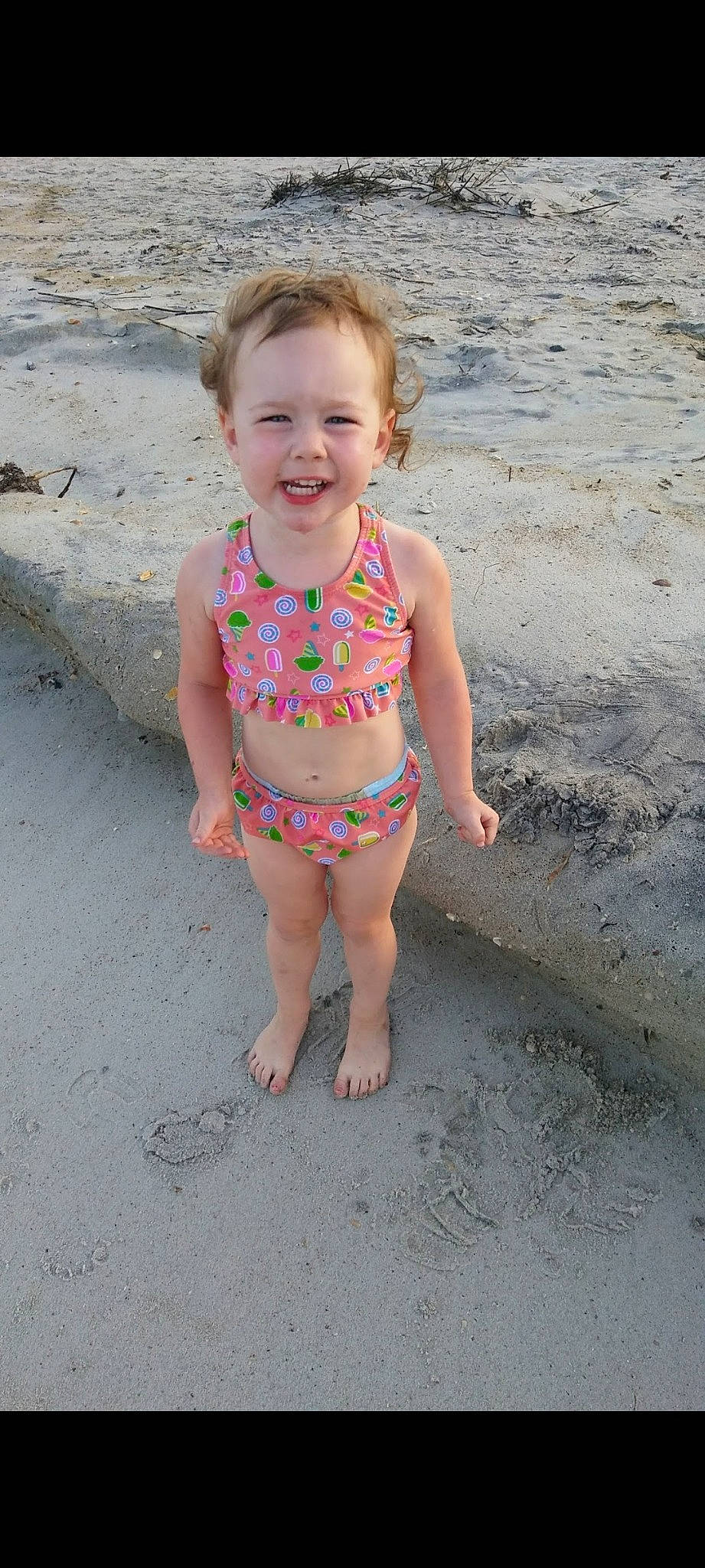 Sophia is registered to the contest to win money with this photo: barefoot, beach, body_of_water, chest, child, eye, face, hair, happy, head, leg, leisure, people_on_beach, person, sand, skin, smile, thigh, toddler, trunk