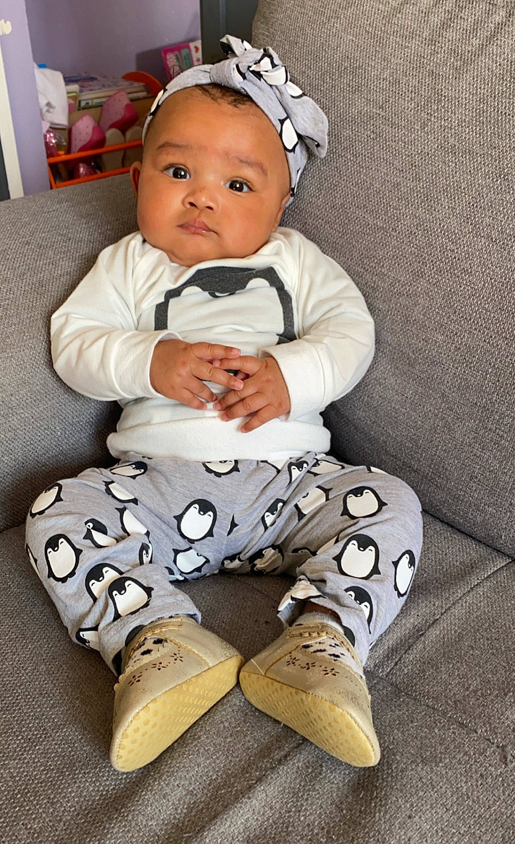 Imany participe au concours pour gagner de l'argent avec cette photo : baby, baby_products, baby_toddler_clothing, child, collar, comfort, dress, face, flooring, formal_wear, grass, happy, human_leg, knee, pattern, person, sitting, sleeve, t_shirt, thigh