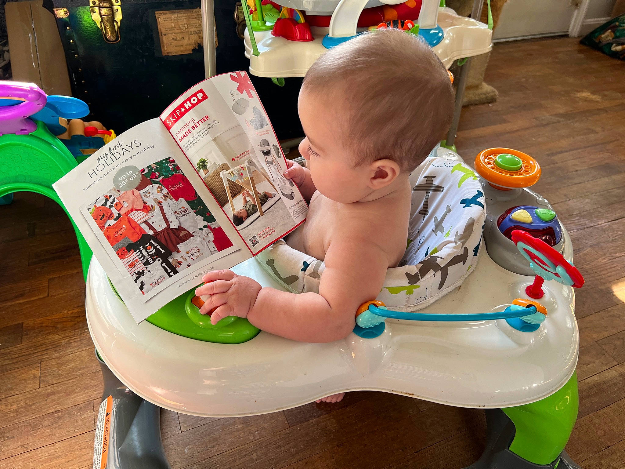 Gray is registered to the contest to win money with this photo: baby, baby_playing_with_toys, baby_products, baby_toddler_clothing, chair, child, flooring, fun, human_leg, lap, leisure, person, play, publication, reading, room, sharing, sitting, thigh, toddler