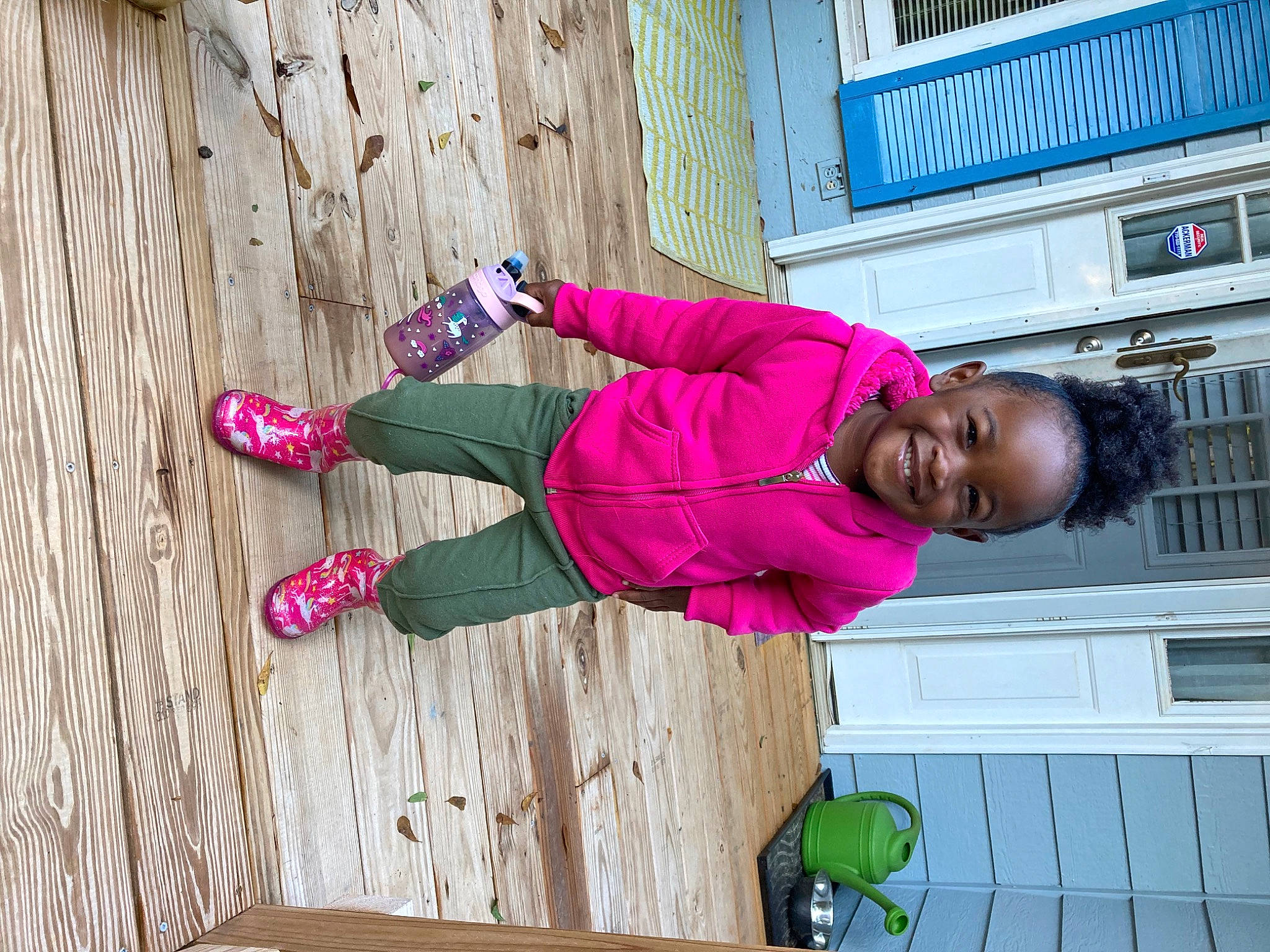 Nia is registered to the contest to win money with this photo: child, electric_blue, fun, happy, hardwood, hat, human_leg, jacket, joy, leisure, magenta, outdoor_shoe, pattern, person, pink, purple, smile, street_fashion, thigh, toddler