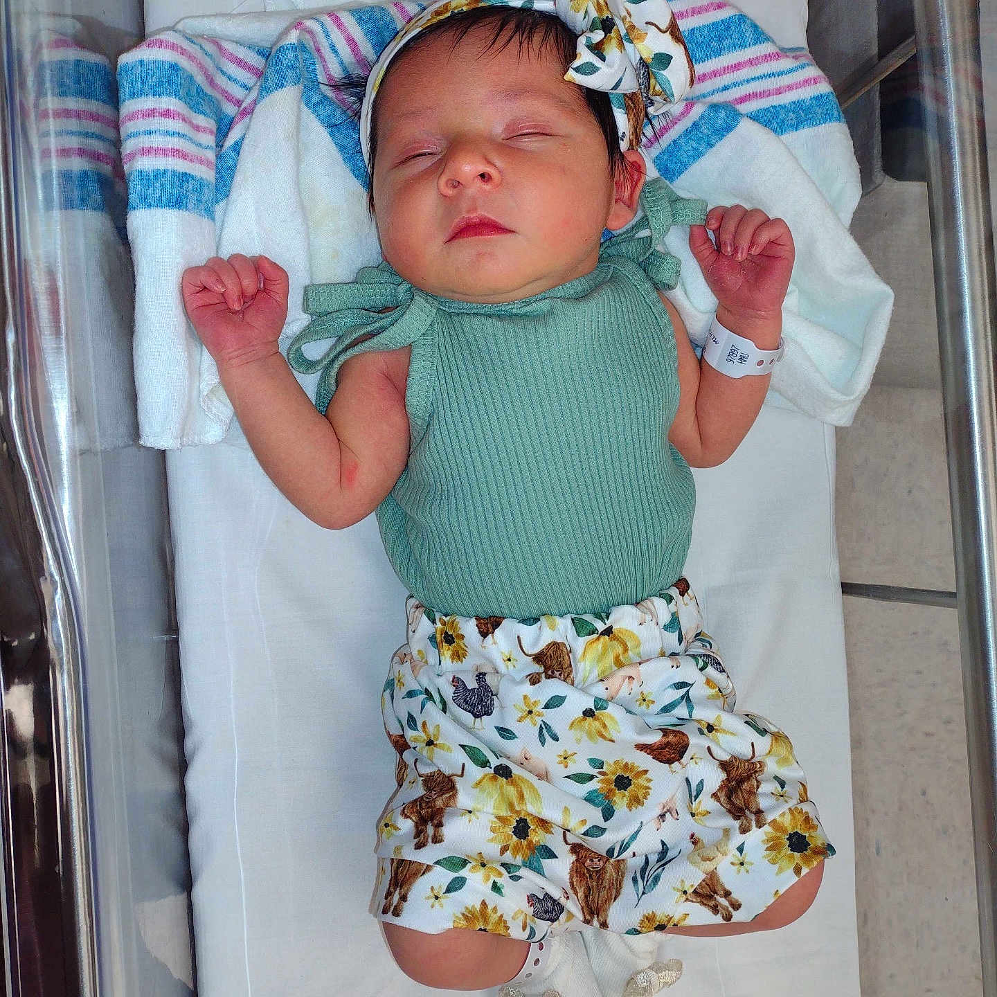 Wrenley is registered to the contest to win money with this photo: baby, baby_clothes, blanket, child, cute, floral_shorts, green_top, headband, hospital, hospital_bassinet, indoor, infant, lying_down, newborn, newborn_baby, peaceful, person, sleep, sleeping, socks