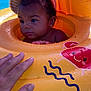 Nëylla a rejoint le concours — aidez-le/la à gagner de superbes lots ! baby, inflatable, pool, water, child, float, yellow, hand, curly_hair, wet, summer, outdoor, cute, swimming, play, face, skin, fun, safety, relax