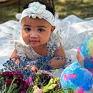 Alexis Sade is registered to the contest to win money with this photo: baby, child, flower, headband, outdoor, nature, portrait, cute, dress, blanket, colorful, greenery, infant, smiling, young, bright, garden, flora, closeup, happy