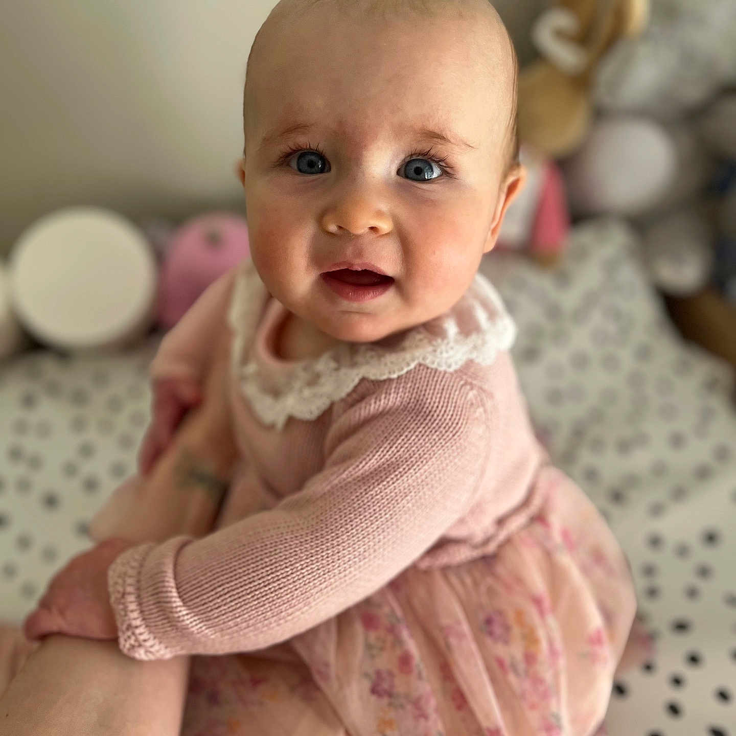 Olivia joined the competition — help win amazing prizes! baby, babylaughing, blanket, blonde, clothing, dress, face, hair, happy, head, laughing, newborn, person, photography, portrait, sitting, sleeve, smile