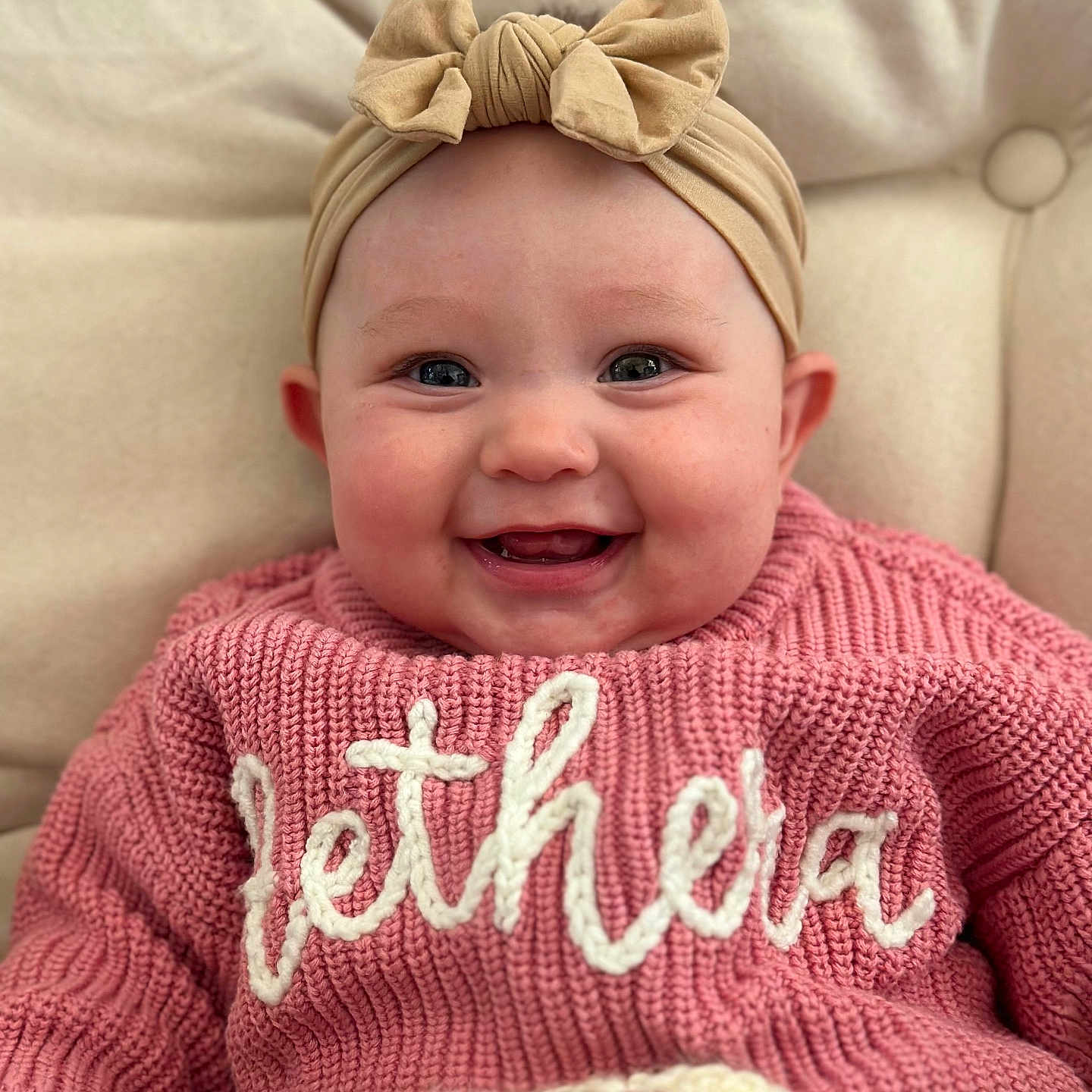 Aethera joined the competition — help win amazing prizes! baby, bow, child, closeup, clothing, cozy, cute, cuteness, face, happy, headband, indoor, infant, knitwear, person, pink_sweater, portrait, smiling, soft_background, warm