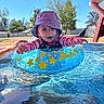 toddler, child, pool, water, inflatable_ring, hat, swimsuit, summer, outdoor, happy, splash, sunny, backyard, blue_sky, trees, play, person, recreation, fun, daytime