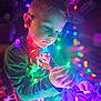Everett joined the competition — help win amazing prizes! child, boy, lights, christmas_lights, colorful, glowing, indoor, curious, holiday, decorations, young, focused, sitting, casual_clothing, long_sleeve_shirt, jeans, closeup, portrait, festive, bright_colors