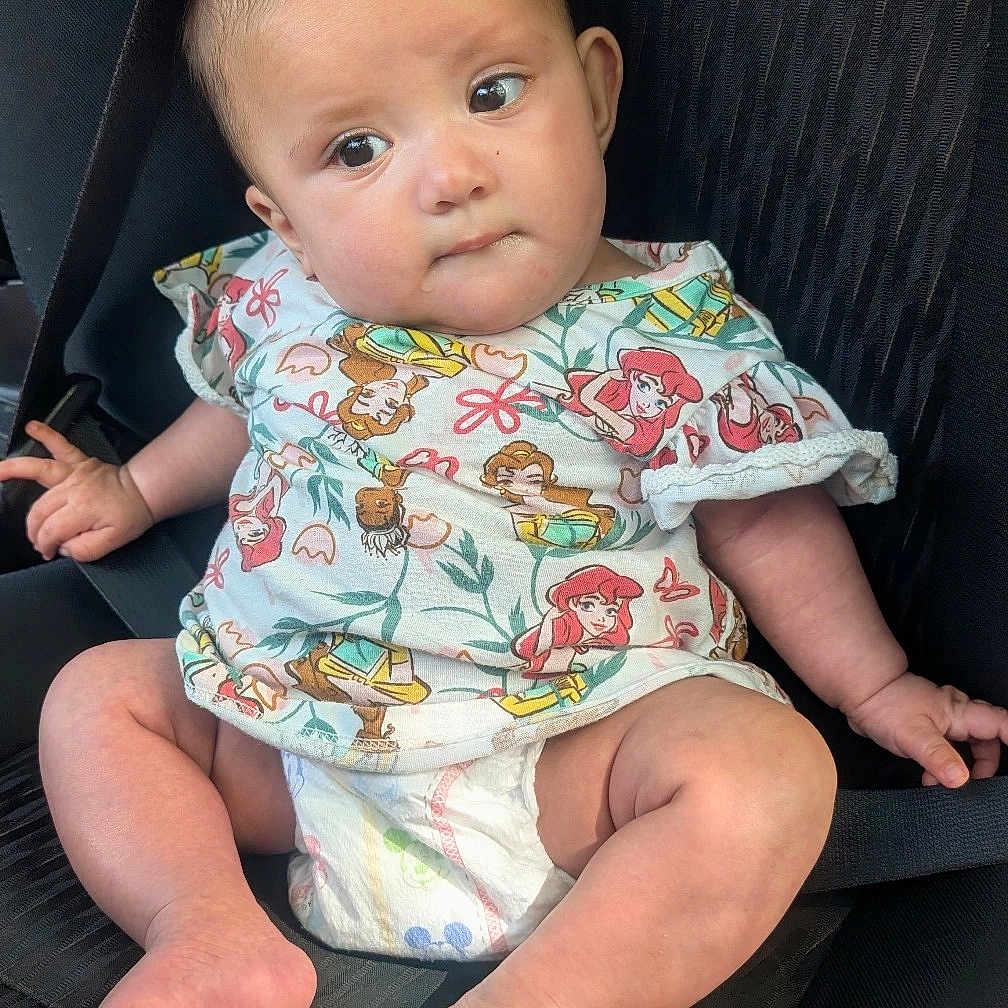 Cayleigh is registered to the contest to win money with this photo: baby, infant, car_seat, diaper, clothing, shirt, child, cute, sitting, expression, person, young, indoors, seatbelt, foot, hand, head, face, skin, casual